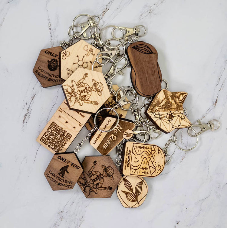 Bulk custom laser engraved wooden keychains in maple and walnut, wholesale and corporate gifting from PRWMade
