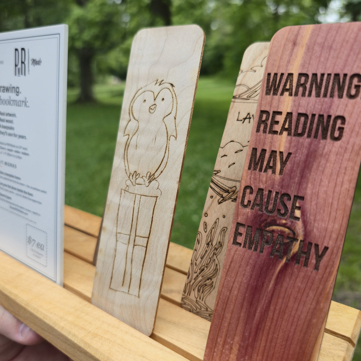 Sample wooden bookmarks made from kids drawings showing variety of woods: maple, cedar, walnut