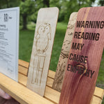 Sample wooden bookmarks made from kids drawings showing variety of woods: maple, cedar, walnut