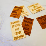 Laser-engraved wood veneer bookmark with “Reading causes empathy,” natural wood grain, rectangular shape, smooth matte finish.