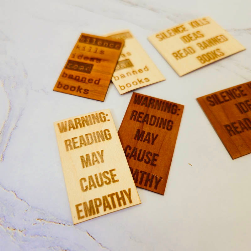 Laser-engraved wood veneer bookmark with “Reading causes empathy,” natural wood grain, rectangular shape, smooth matte finish.