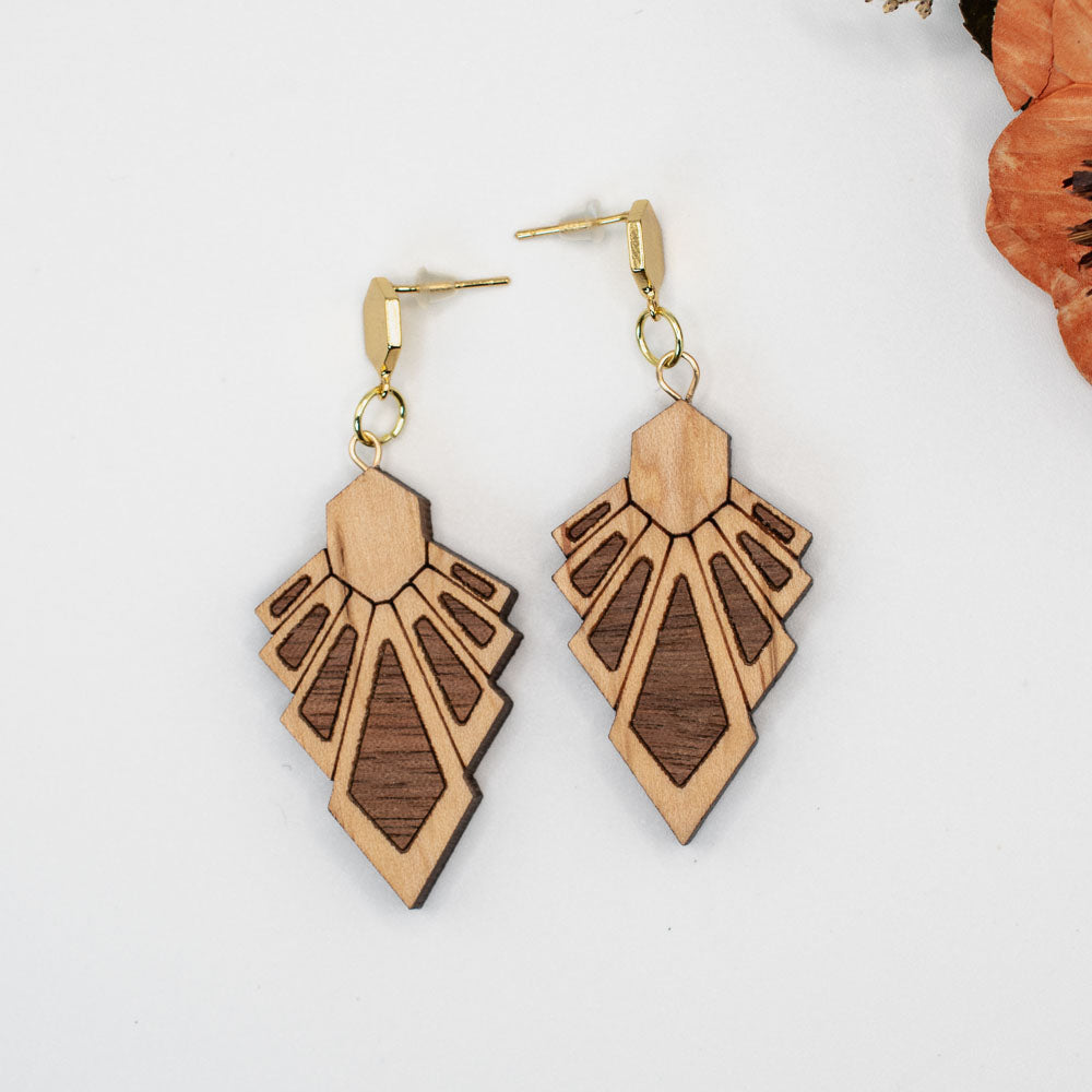 Wooden earrings with gold accents on a white background