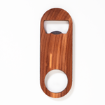 Handcrafted cedar wood oval bottle opener with metal edge, large circular cutout at base. Laser-engraved, smooth finish.
