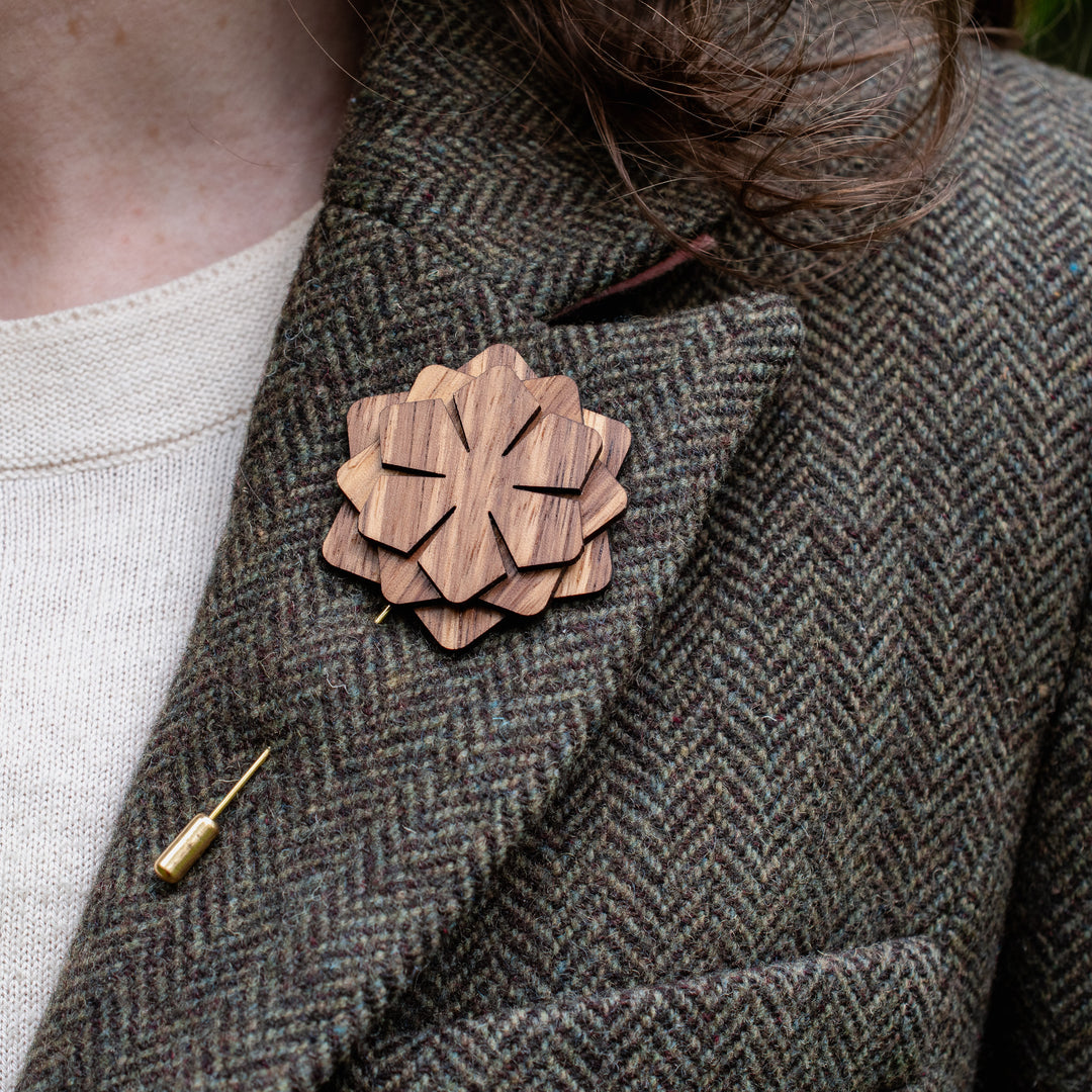 Wooden brooch on a textured coat