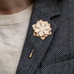 Wooden flower lapel pin on a textured blazer