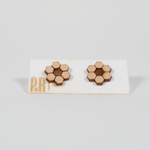 Hive wood stud earrings with laser-engraved honeycomb pattern, natural wood finish on white card with gold PRW Made branding.