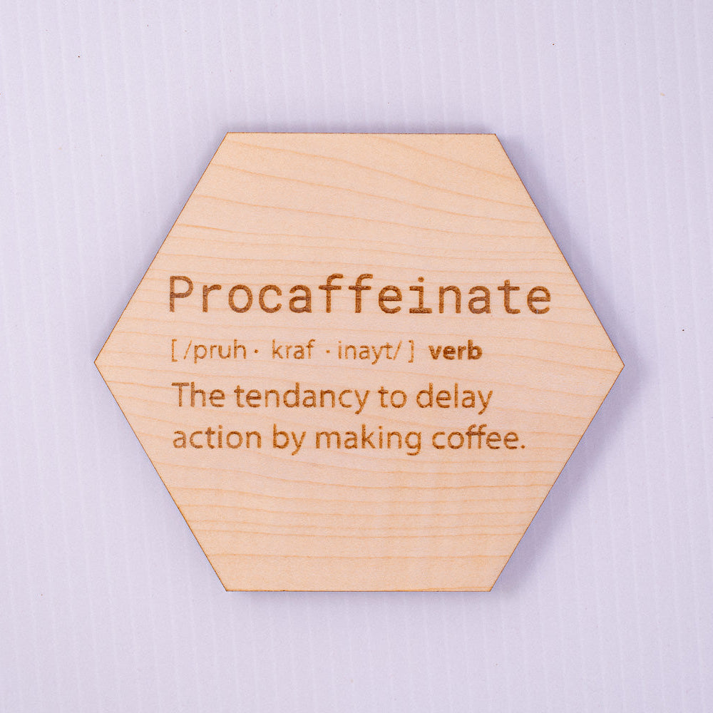 Hexagonal wooden sign with the word 'Procaffeinate' and its definition on a light purple background