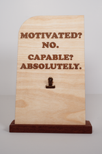 Handmade Ohio wooden message board with clip, rectangular shape, engraved with “MOTIVATED? NO. CAPABLE? ABSOLUTELY.” Natural finish.