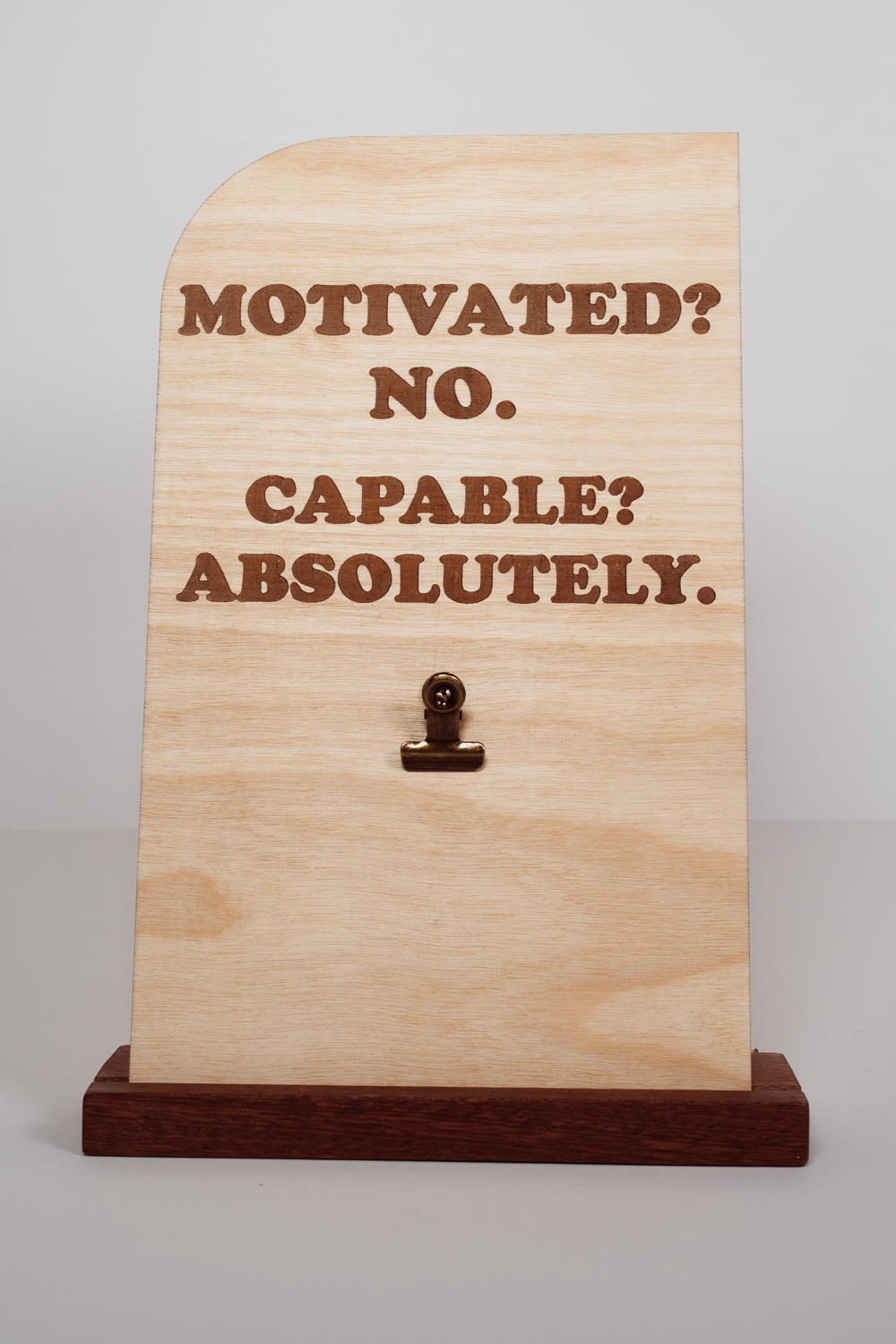 Handmade Ohio wooden message board with clip, rectangular shape, engraved with “MOTIVATED? NO. CAPABLE? ABSOLUTELY.” Natural finish.