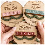 Personalized name Christmas ornaments in Baltic birch with colored block-letter name tiles and engraved holiday phrases