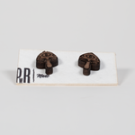 Walnut wood stud earrings, mushroom-shaped with engraved eye detail, geometric design. Hypoallergenic posts, displayed on card.