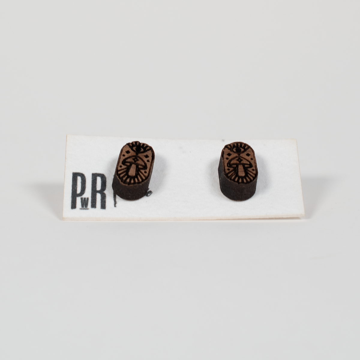 Walnut wood Small Stud Earrings with laser-engraved geometric patterns, dark brown finish, shown on a white PRW Made display card.