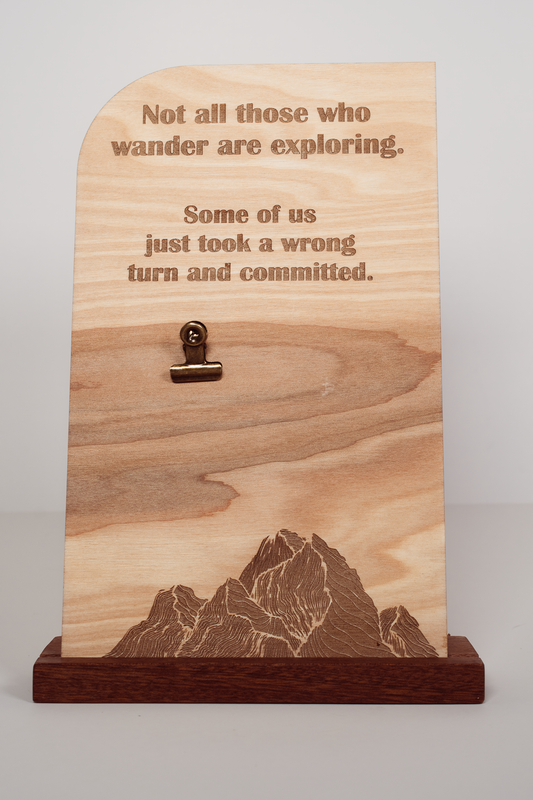 Laser-engraved wooden message board with mountain design, engraved text, clip holder, and handmade upright wood stand.