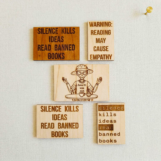 Set of five laser-engraved wood stickers with Reading causes empathy and a whimsical alien design labeled Area 51 was wild.