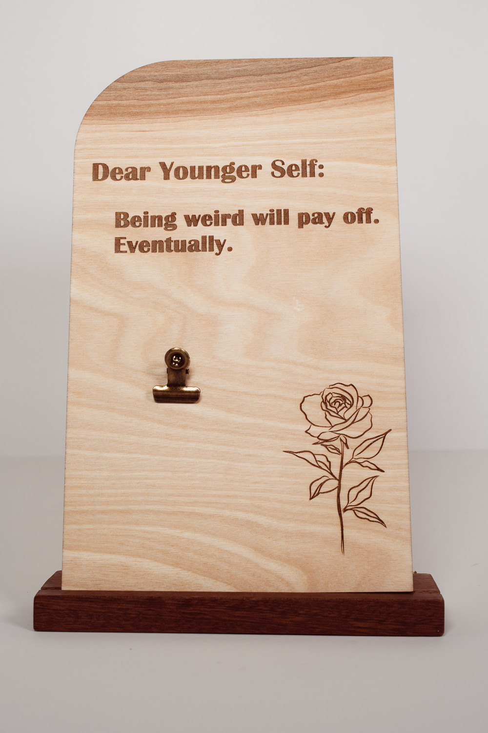 Handmade wooden message board with clip, engraved with Dear Younger Self: Being weird will pay off. Eventually, and a rose.