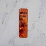 Aromatic cedar bookmark with Warning: Reading May Cause Empathy in bold lettering, knotty red grain, by PRWMade