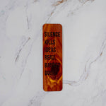 Aromatic cedar bookmark with Silence Kills Ideas Read Banned Books in bold filled lettering, knotty red grain, by PRWMade