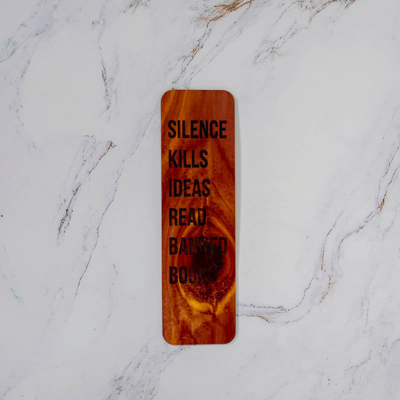 Aromatic cedar bookmark with Silence Kills Ideas Read Banned Books in bold filled lettering, knotty red grain, by PRWMade