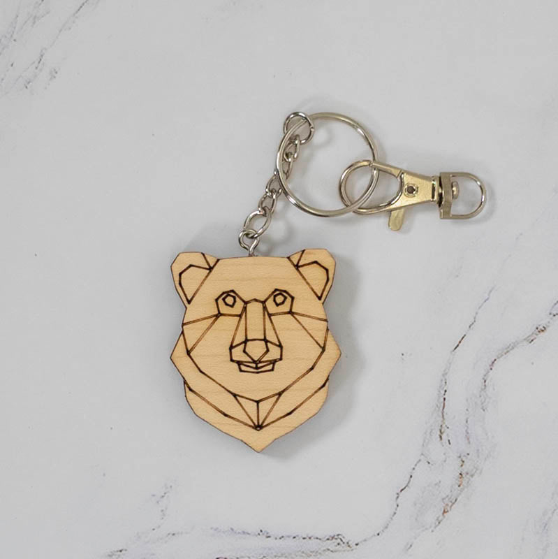 Geometric bear head wood keychain laser cut and engraved from maple with low-poly line art, silver clasp and split ring, handmade in Ohio by PRWMade
