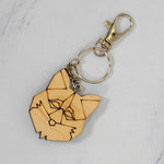 Geometric fox head wood keychain laser cut from maple with low-poly faceted line art, silver clasp and split ring, handmade in Ohio by PRWMade