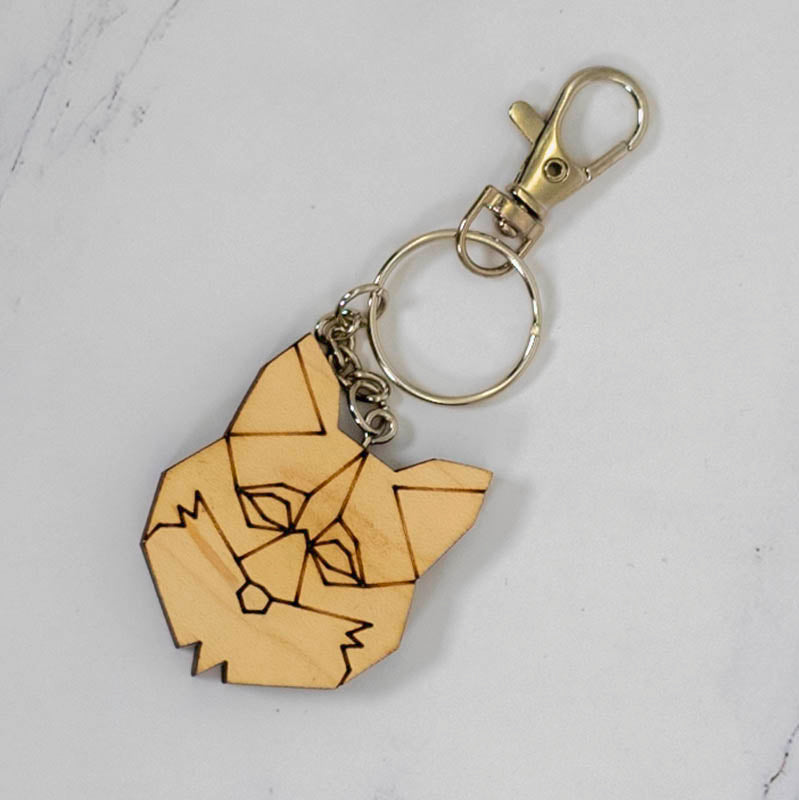 Geometric fox head wood keychain laser cut from maple with low-poly faceted line art, silver clasp and split ring, handmade in Ohio by PRWMade