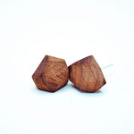 Handcrafted geometric wood stud earrings with ½″ faceted surfaces, natural finish, and sterling silver posts on white background.