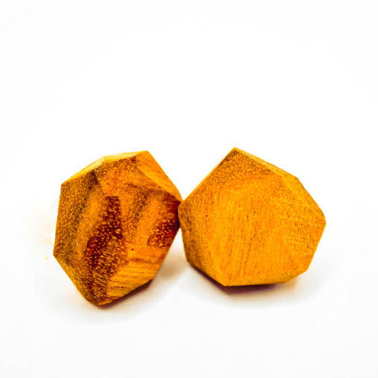 Two yellow crystal-like objects on a white background