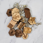 The caffeine molecule wooden keychain shown with the wider PRWMade wooden keychain collection in maple and walnut, for scale and wood comparison