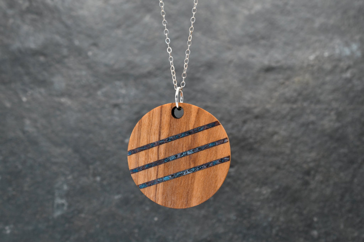 Round wood and stone inlay pendant in Walnut with crushed Lapis Lazuli, sterling silver chain