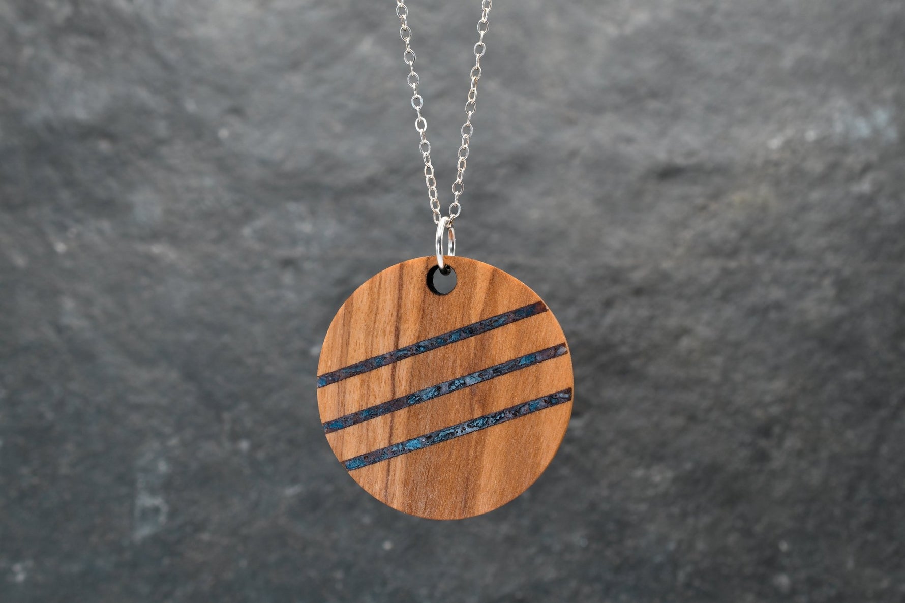 Round wood and stone inlay pendant in Walnut with crushed Lapis Lazuli, sterling silver chain