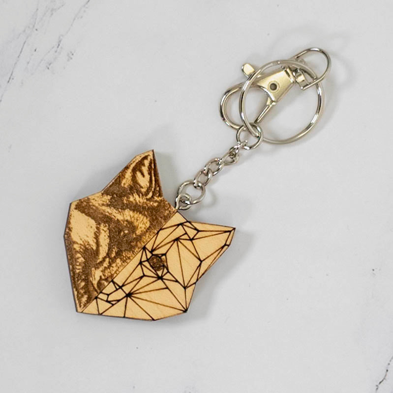 Geometric half fox wood keychain in maple, one side photo-engraved with a realistic fox and the other in low-poly line art, handmade in Ohio by PRWMade