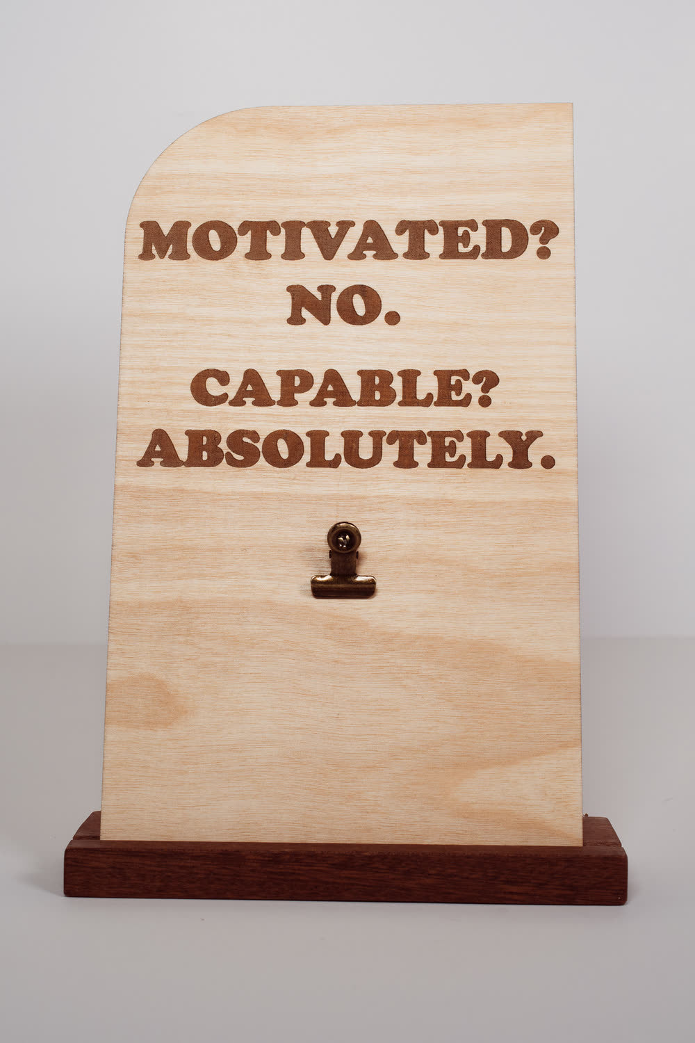 Engraved wooden message board with clip reading Motivated? No. Capable? Absolutely., natural finish desk sign handmade in Ohio