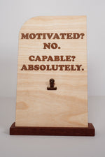Engraved wooden message board with clip reading Motivated? No. Capable? Absolutely., natural finish desk sign handmade in Ohio