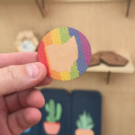 Ohio rainbow pride border cherry wood magnet shown in hand