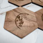 Close-up of a walnut hexagon coaster with detailed waxing crescent moon laser engraving