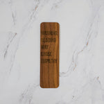 Walnut wood bookmark engraved Warning: Reading May Cause Empathy in outline lettering, dark grain, by PRWMade