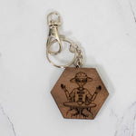 Walnut hexagon wood keychain laser-engraved with a retro Area 51 alien design, silver clasp and split ring, handmade in Ohio by PRWMade