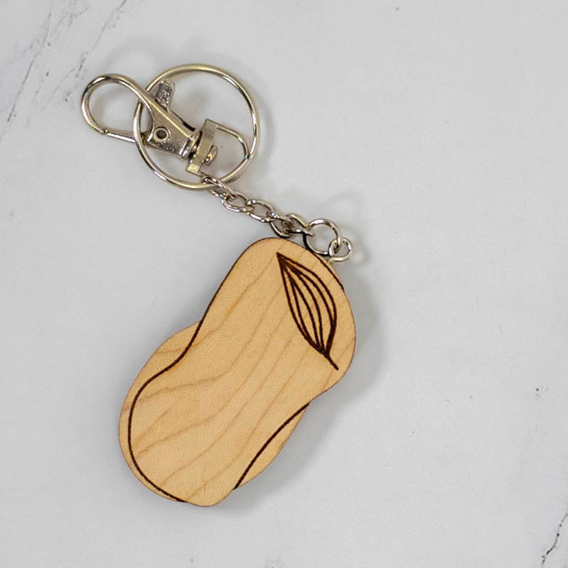 Large organic pebble-shaped maple wood keychain engraved with a botanical leaf line drawing, silver clasp and split ring, handmade in Ohio by PRWMade